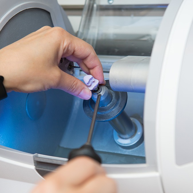 Dentist retreiving CEREC Crown in Carrollton